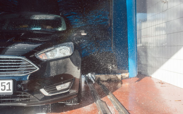 black sedan existing an iba car wash